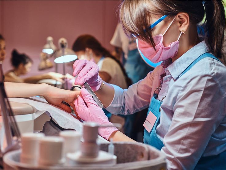 Expert nail artist performing manicure treatment in luxury salon